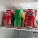 Drink pusher system used to keep soda and beverages aligned inside fridge.