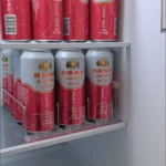 Shelf pusher keeping retail drink shelves tidy and perfectly front-facing.