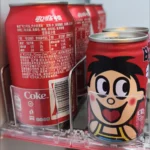 Shelf pushers installed in a home refrigerator for bottled drinks organization.