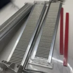 Customer using shelf pusher rail for organizing drink display shelves.