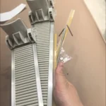 Retail store refrigerator showing neatly aligned drinks using push-feed rails.