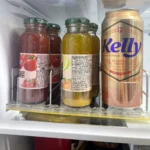 Shelf pusher system installed in convenience store drink refrigerator.