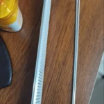 Push rail system used for drink organization inside grocery refrigerator.