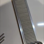 Shelf pusher rails prepared for installation in refrigerator beverage shelves.