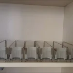 Customer photo showing spring-loaded drink pusher system for retail shelves.