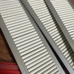 Customer installation photo of shelf pusher keeping canned beverages front-facing.