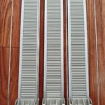 Retail fridge with shelf pusher rails showing improved product visibility.