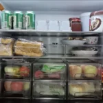 Organized retail can display using auto-feeding shelf pusher system.